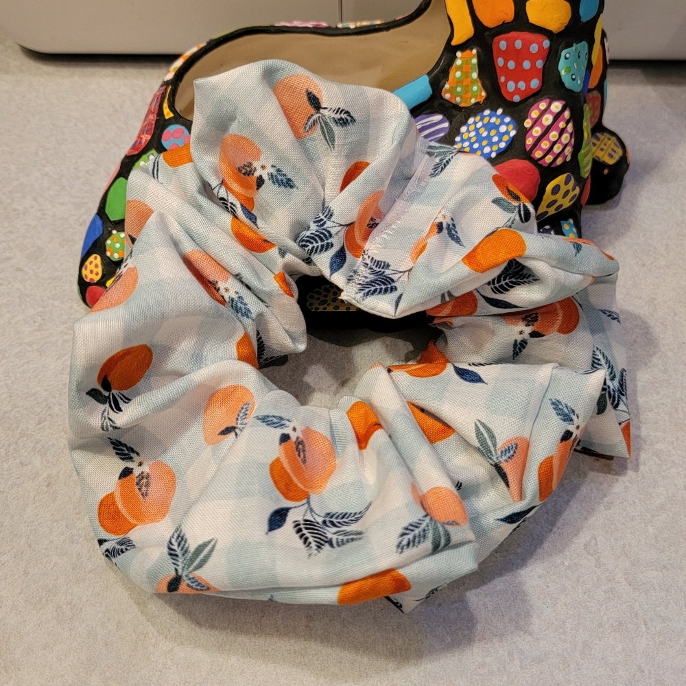 Scrunchie with oranges, gingham, and blossoms.
